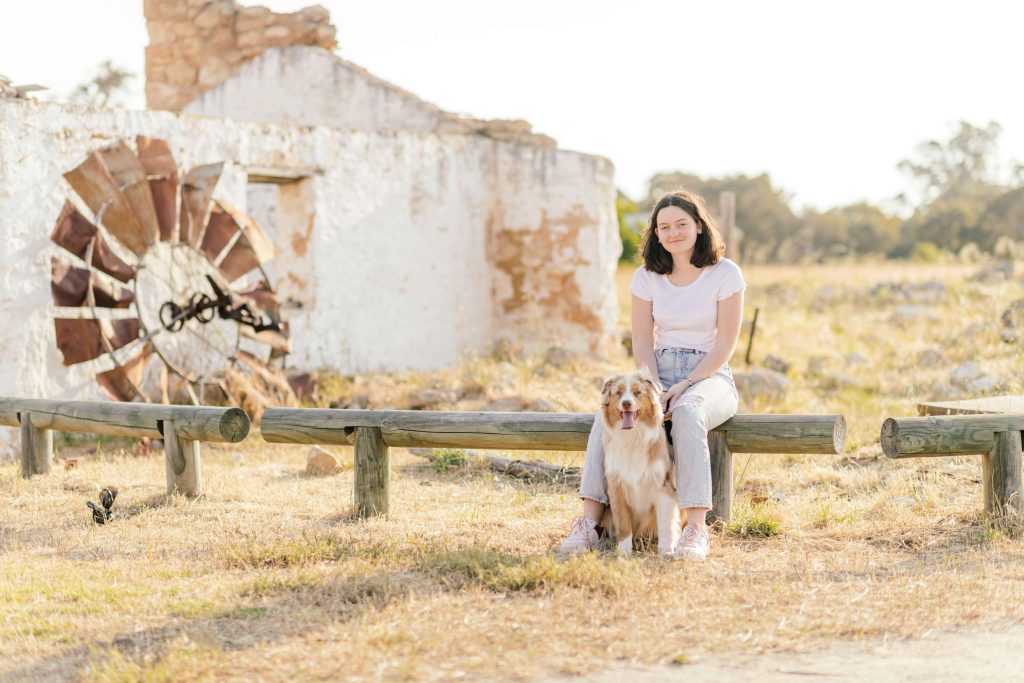 Me, Mya, and my pup, Olive, sitting in a field at Yellagonga Regional Park.